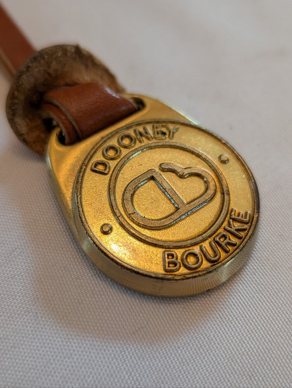 Dooney & Bourke Gold-Tone Round Logo Key Fob with Brown Strap